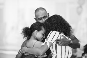 Dad and daughters hugging